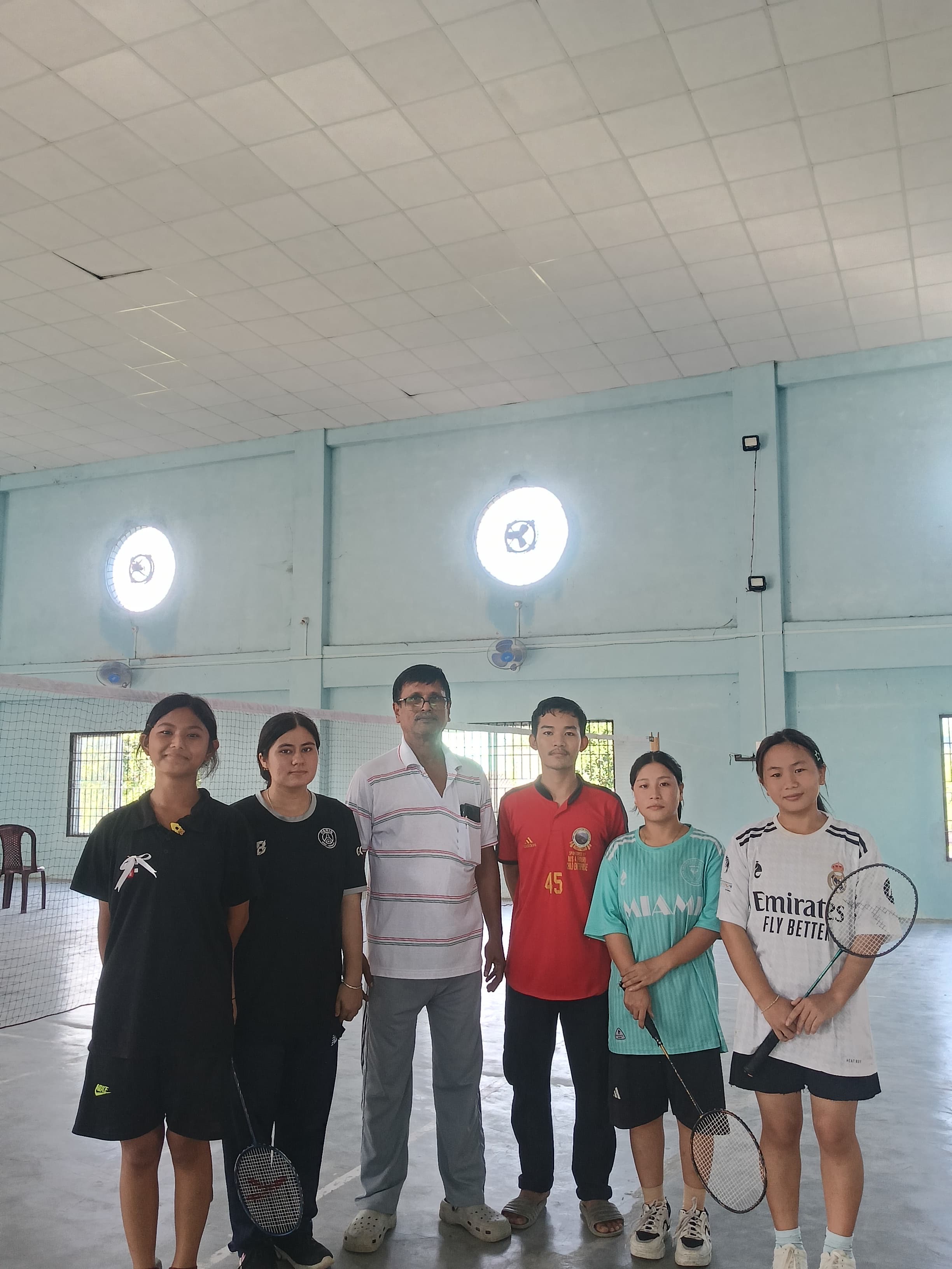 School badminton team with coach